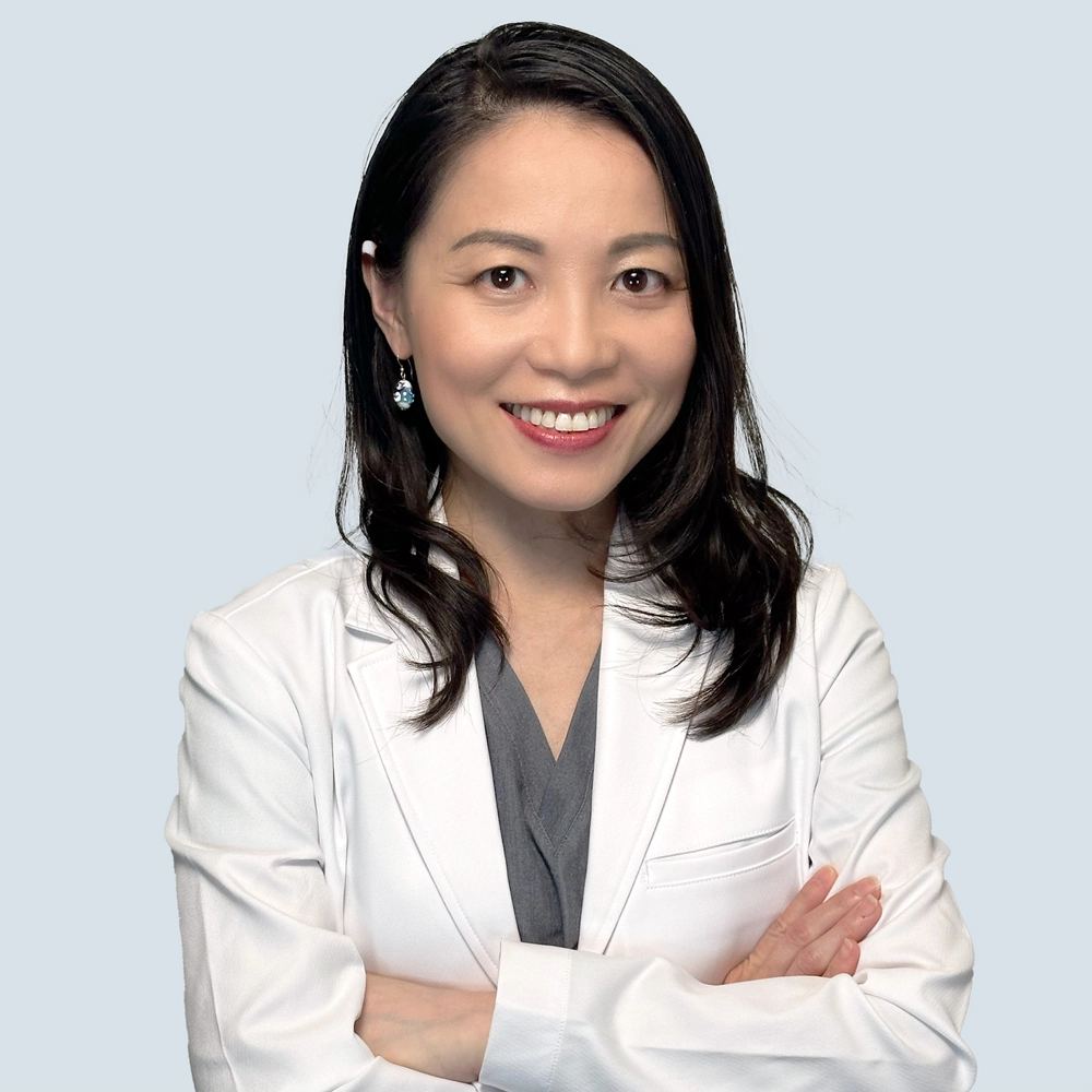 Professional photograph of Dr. Rita Chuang in lab coat in studio