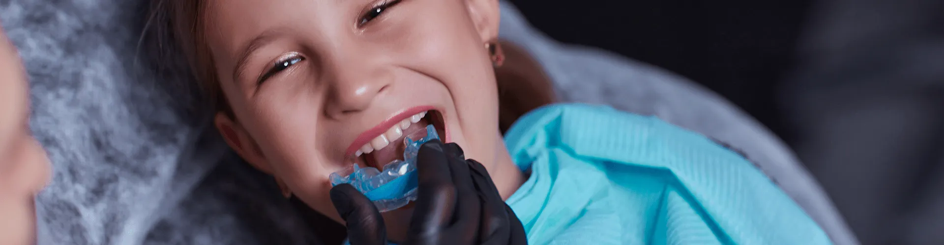 child being fitted for a myofunctional therapy device