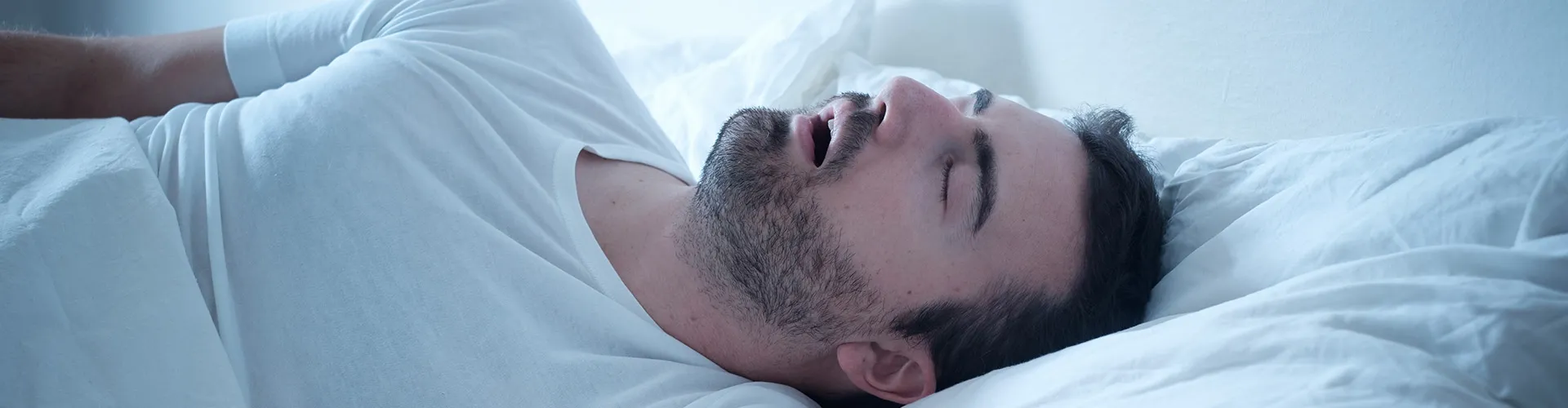 man sleeping on his back with his mouth open