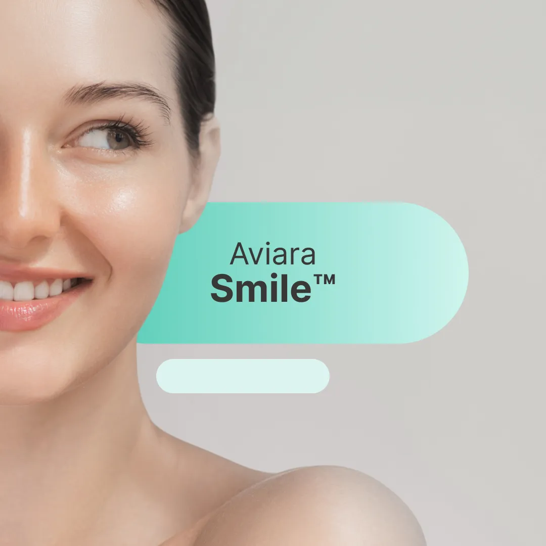 Happy young woman with blonde hair smiling broadly.