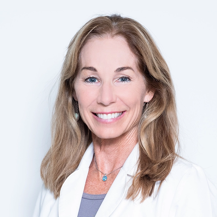 Professional photograph of Paula Torres in lab coat in studio