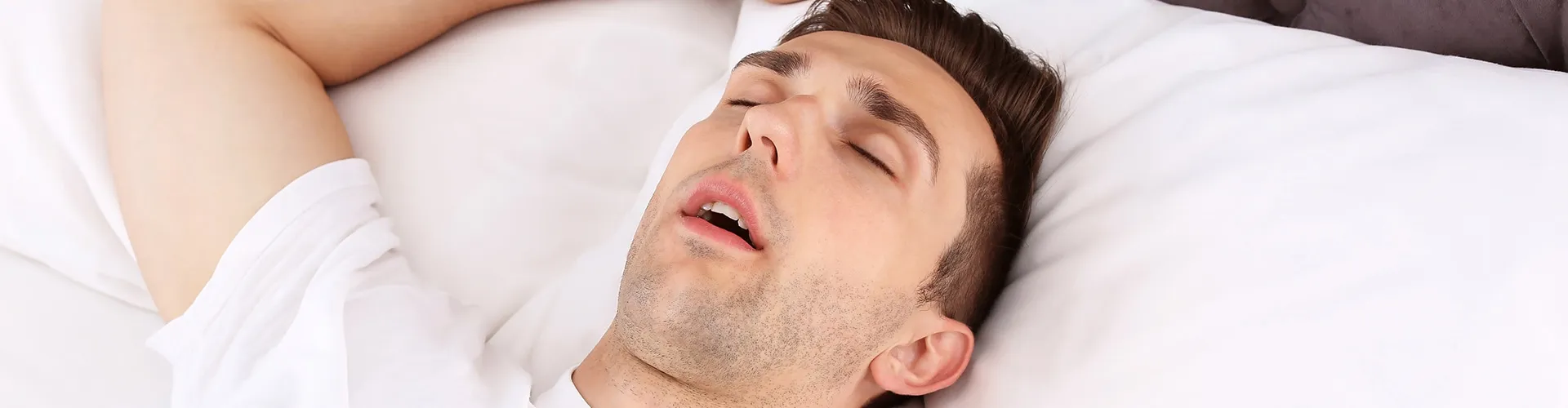 man asleep on his back with his mouth open