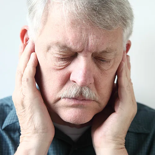 man holding his jaw joints