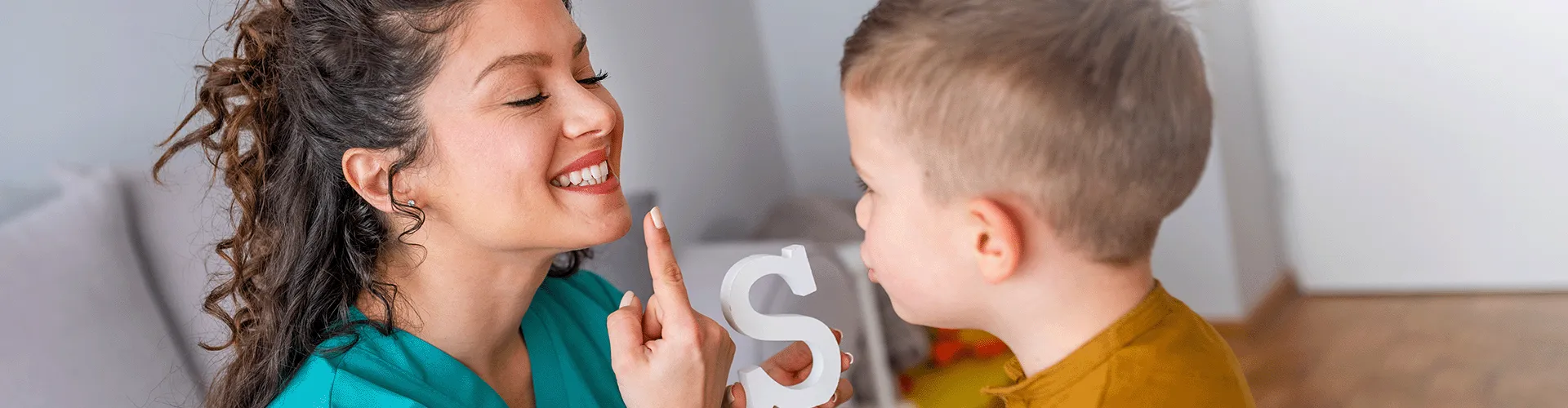 dentist showing child how to make the 's' sound